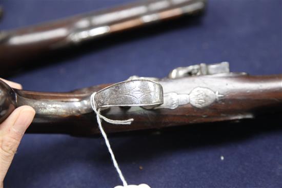 A pair of late 18th century flintlock holster pistols, 15in.